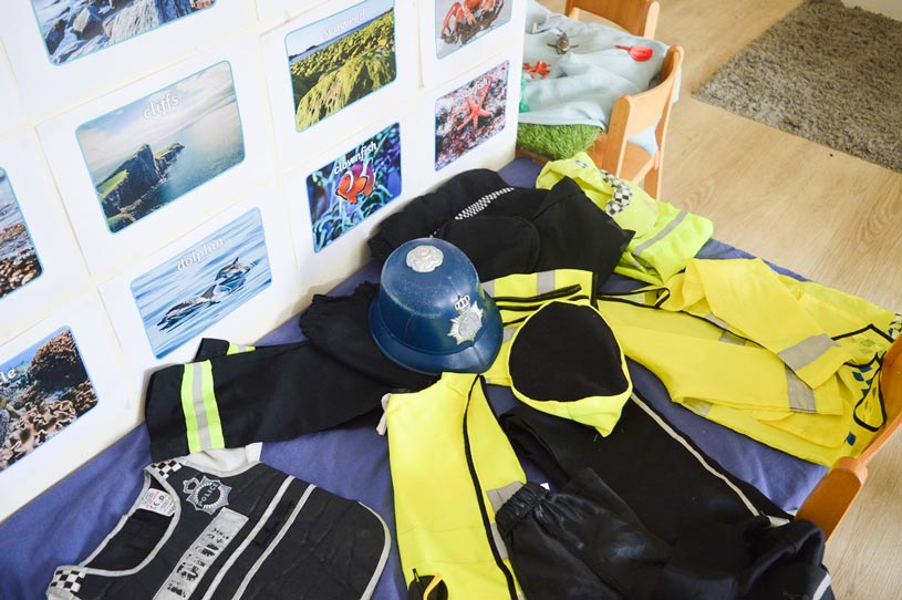 a table of children's police uniform costumes