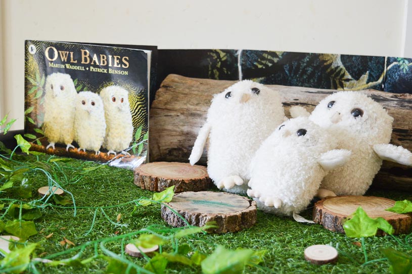 three owl plushies next to the book 'owl babies'