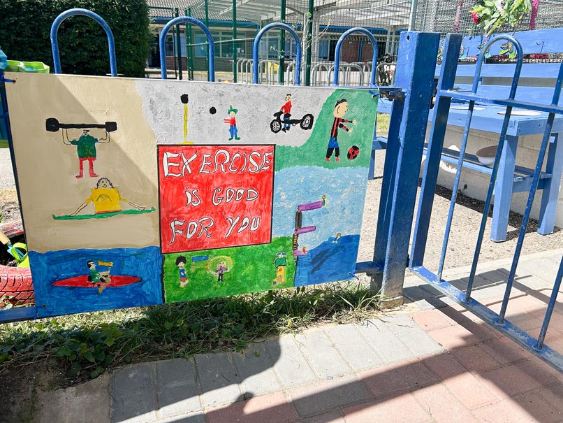a hand painted sign on a blue fence that says 'exercise if good for you'